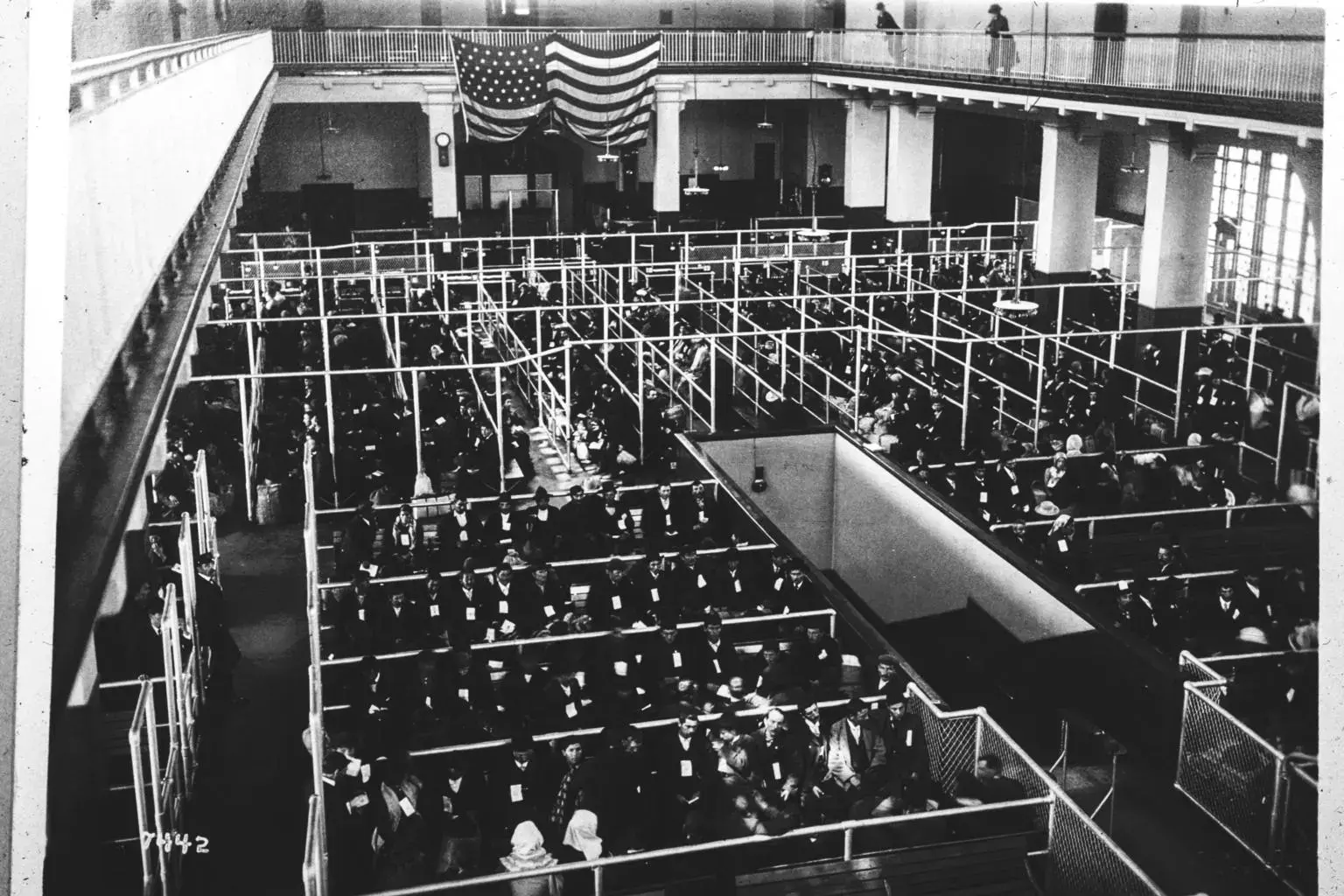 Arrivals waiting in the pens of the Ellis Island Registry Room